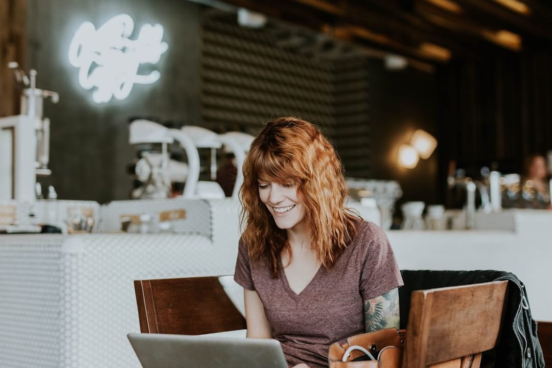 A female employee accessing her earned wages using a laptop